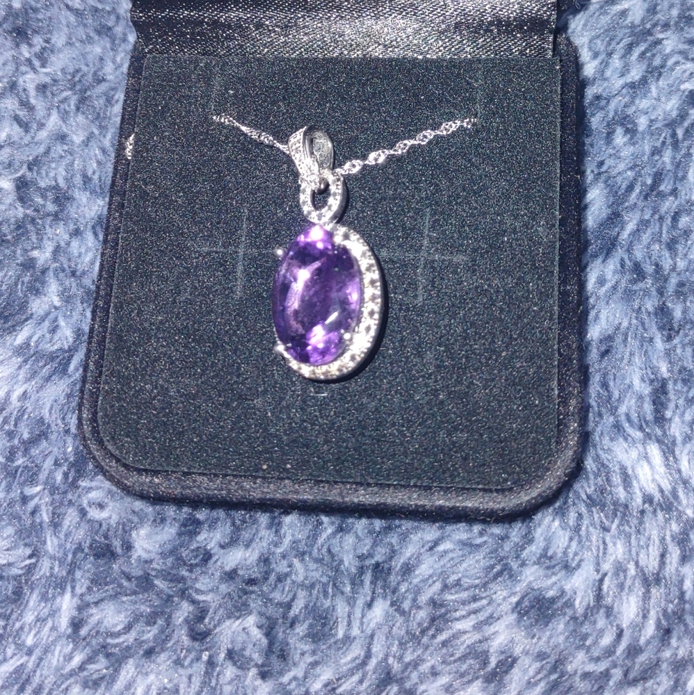 Amethyst and silver pendant, surrounded by halo cut diamond.